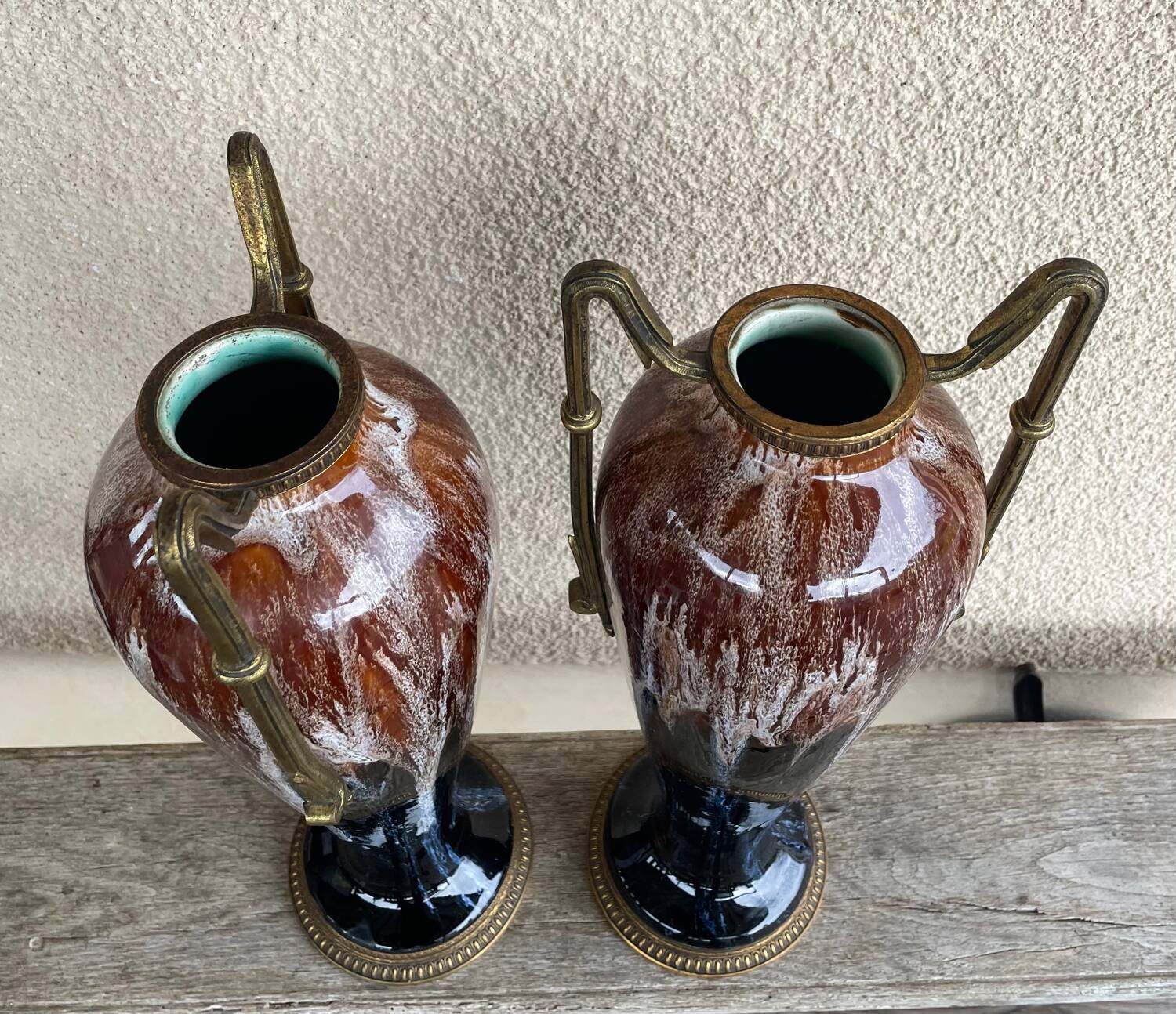 Two large stoneware vases with bronze fittings.