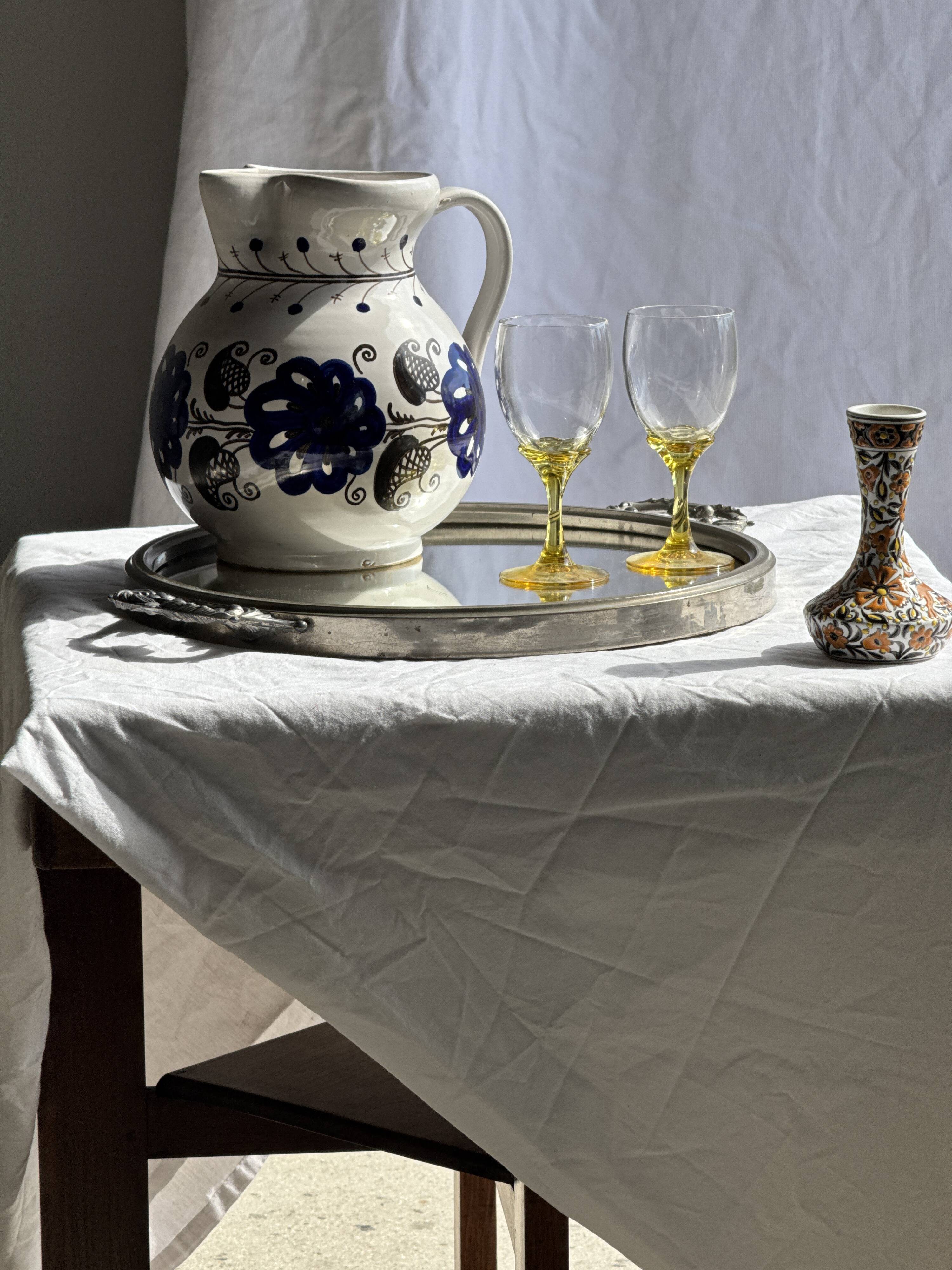 Very large vintage ceramic carafe in white glazed with blue floral decoration.