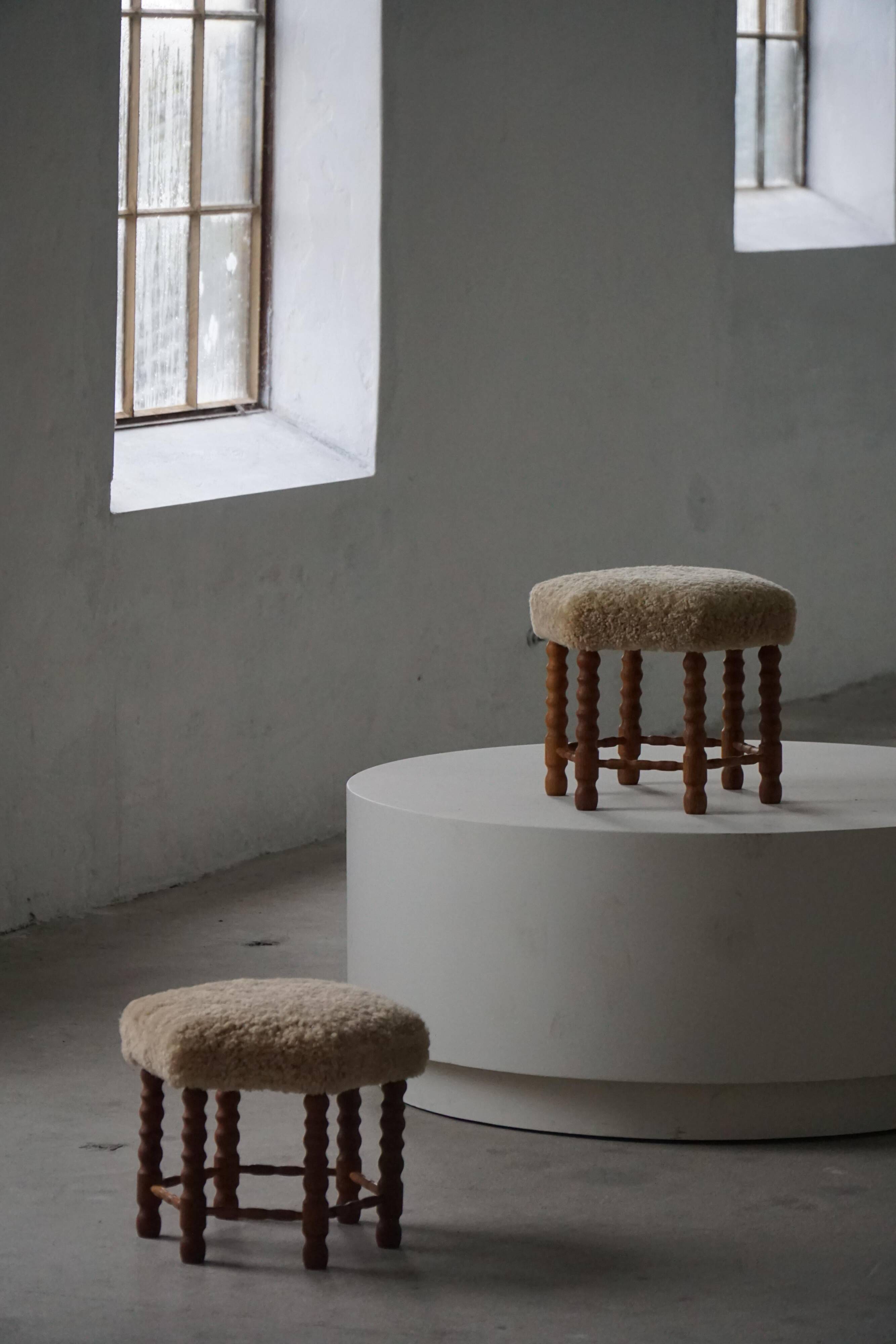 Pair of Danish oak stools from the mid-century with hexagonal seat and turned legs, 1950s.