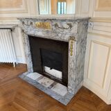 Louis XVI fireplace in veined grey marble with original gilded bronzes from the 19th century.