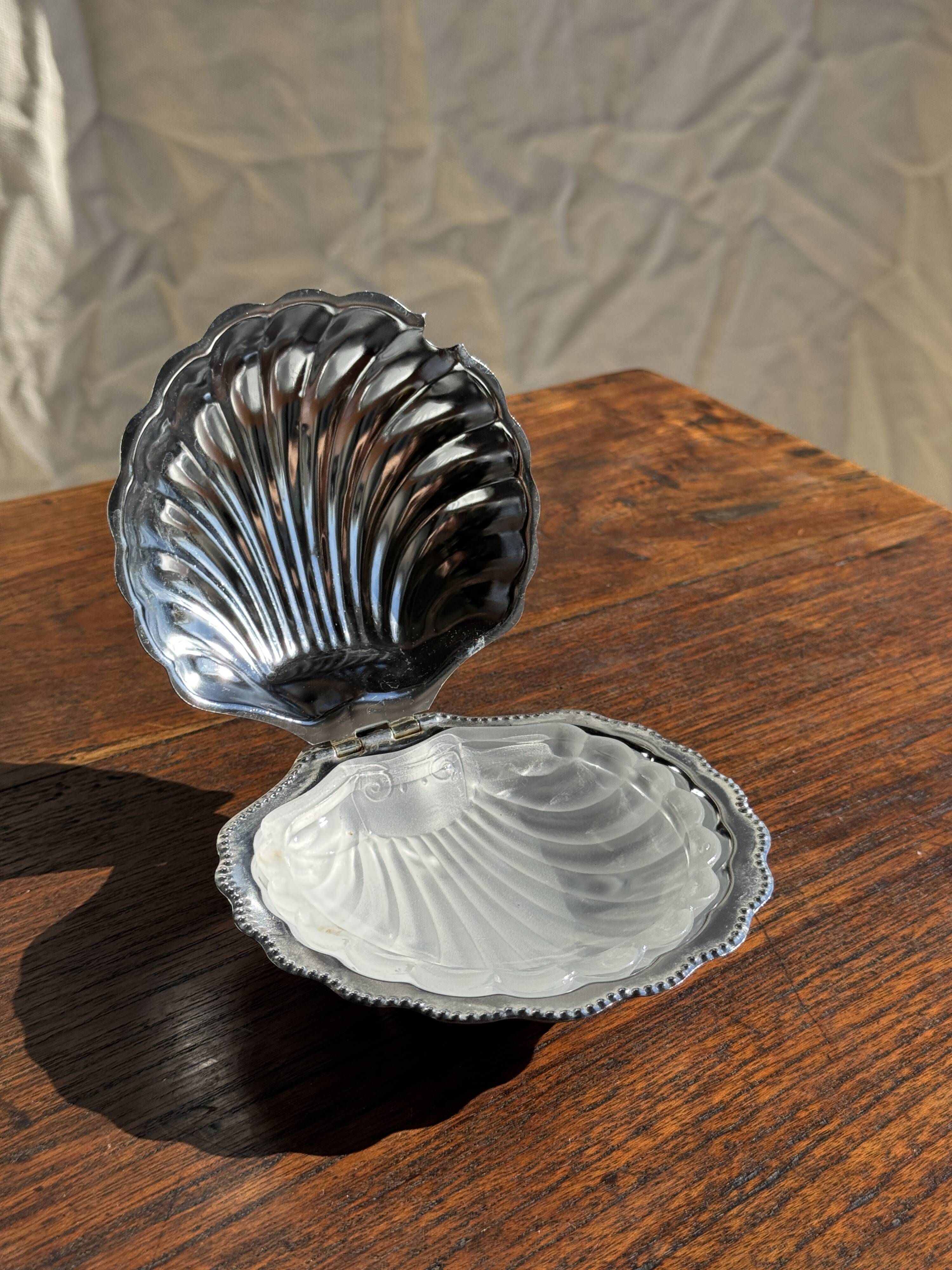 Vintage silver-plated shell butter dish with transparent bowl.