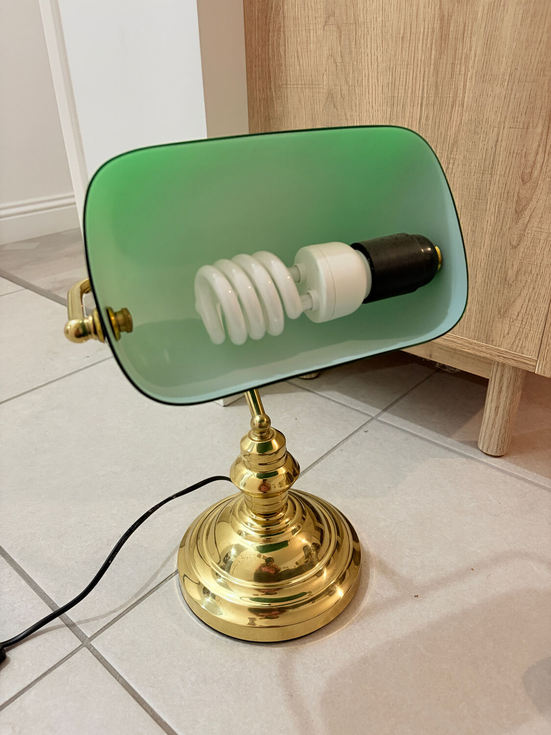 Gold and green banker’s desk lamp.