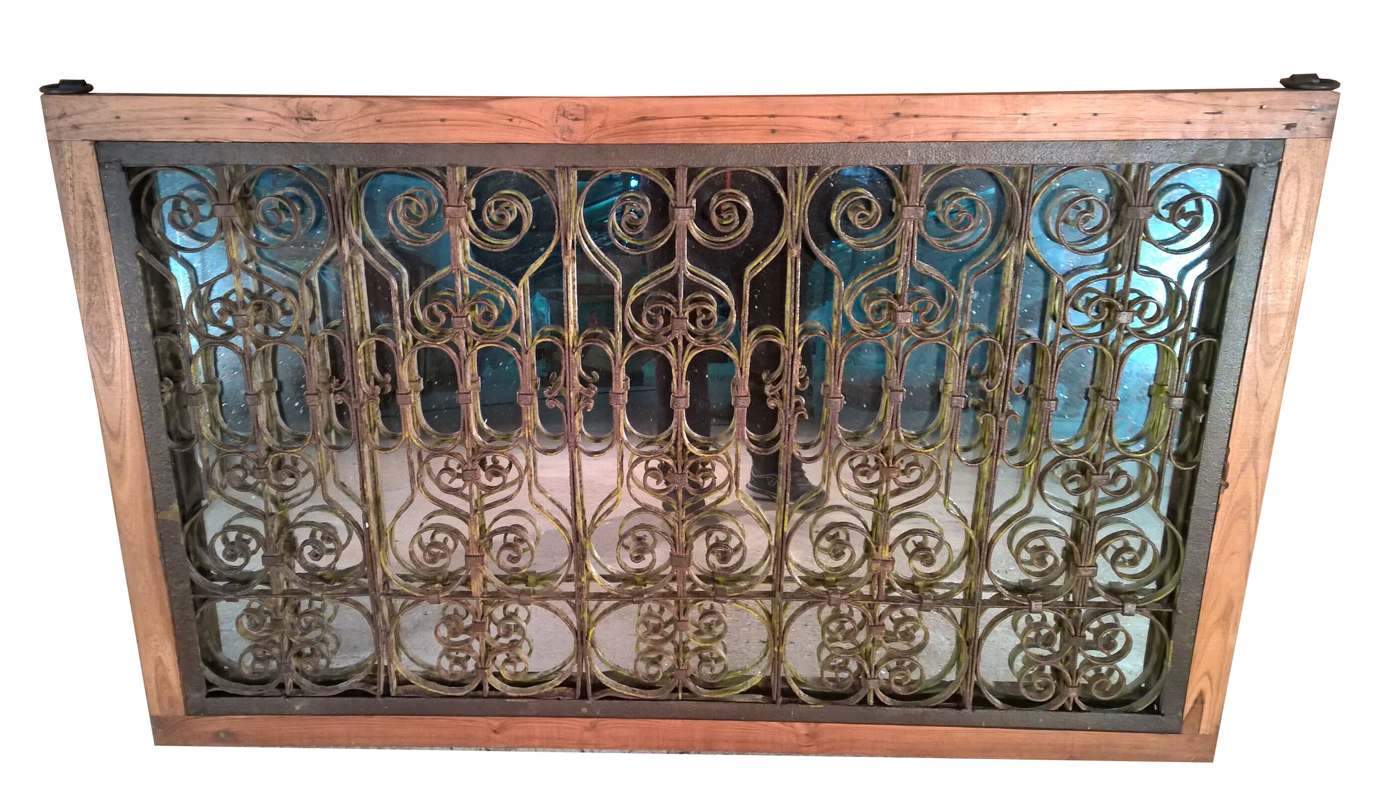 Old wrought iron railing with mirror and teak frame