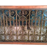 Old wrought iron railing with mirror and teak frame