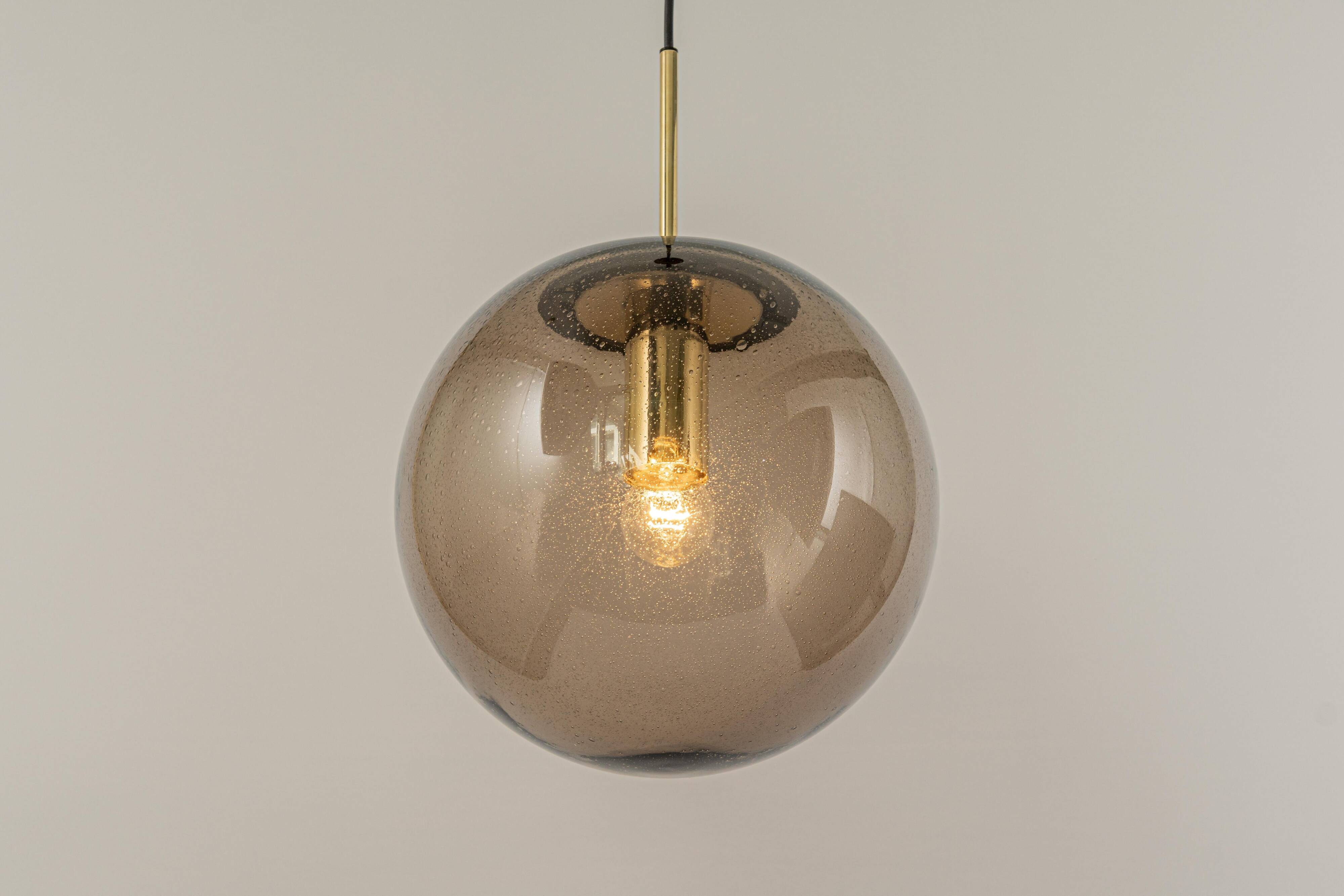 Large smoked glass ball pendant by Limburg in brass, Germany, 1970s.