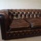 Vintage three-seater brown leather Chesterfield sofa