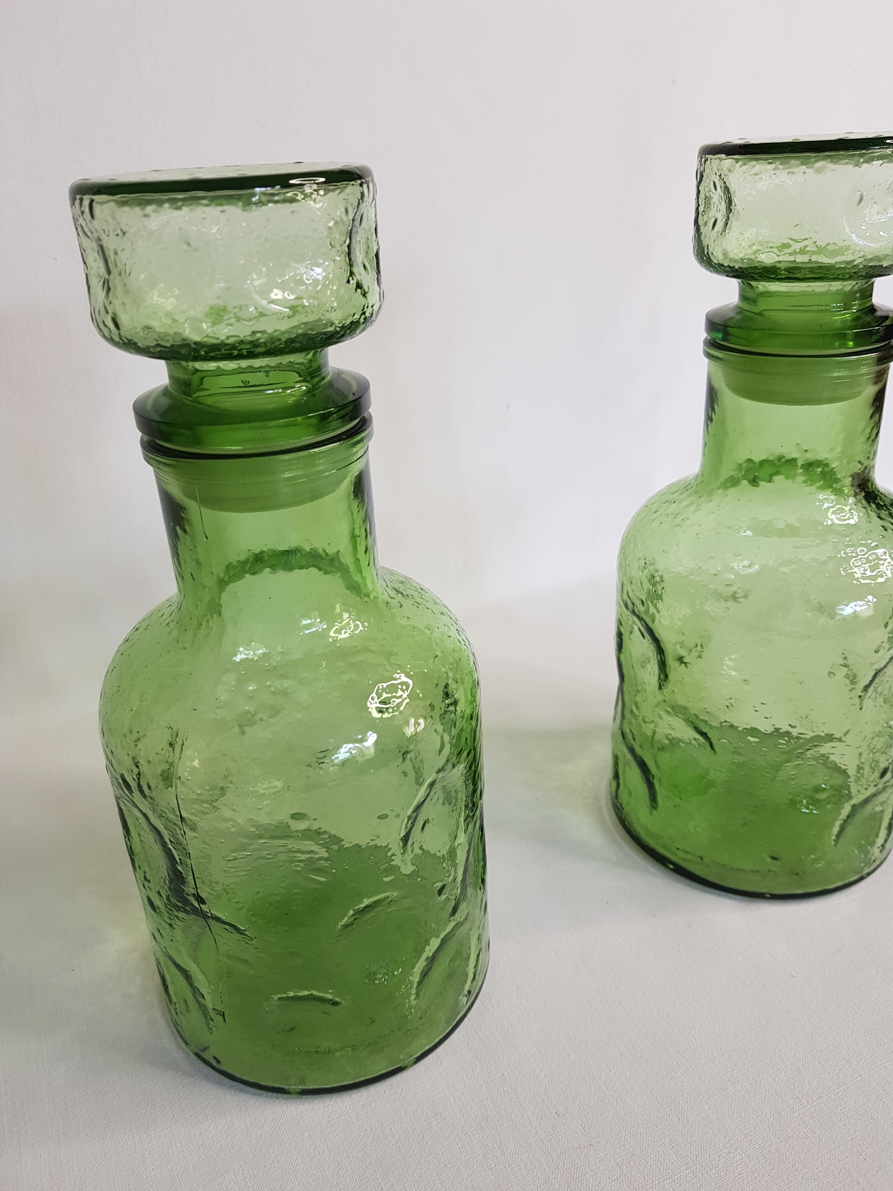 Pair of green moulded glass bottles 70s