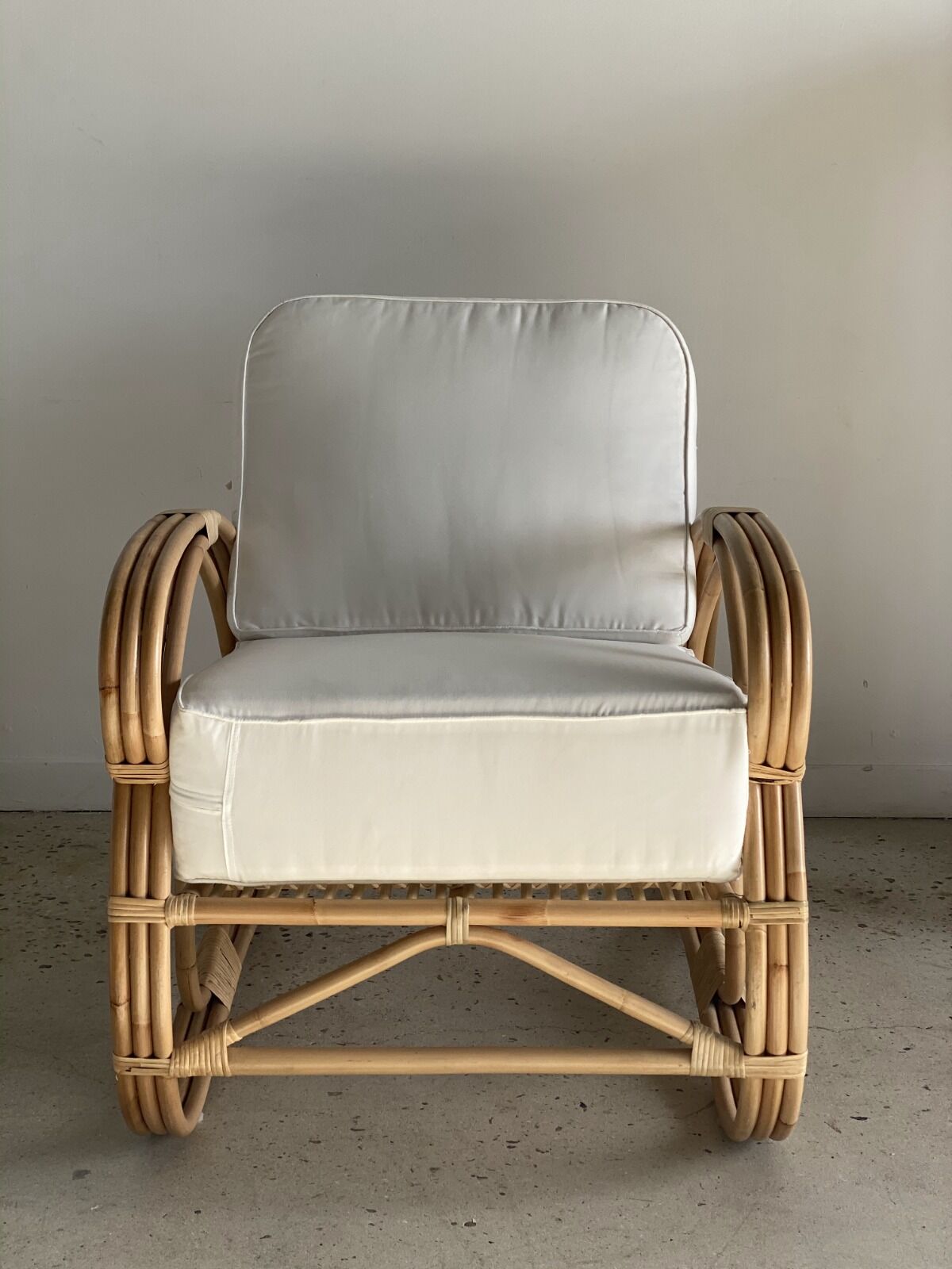 Large rattan rest chair and white cushions