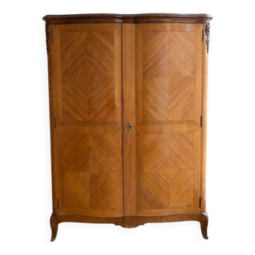 Antique Louis XV wardrobe in wood with chevron pattern.