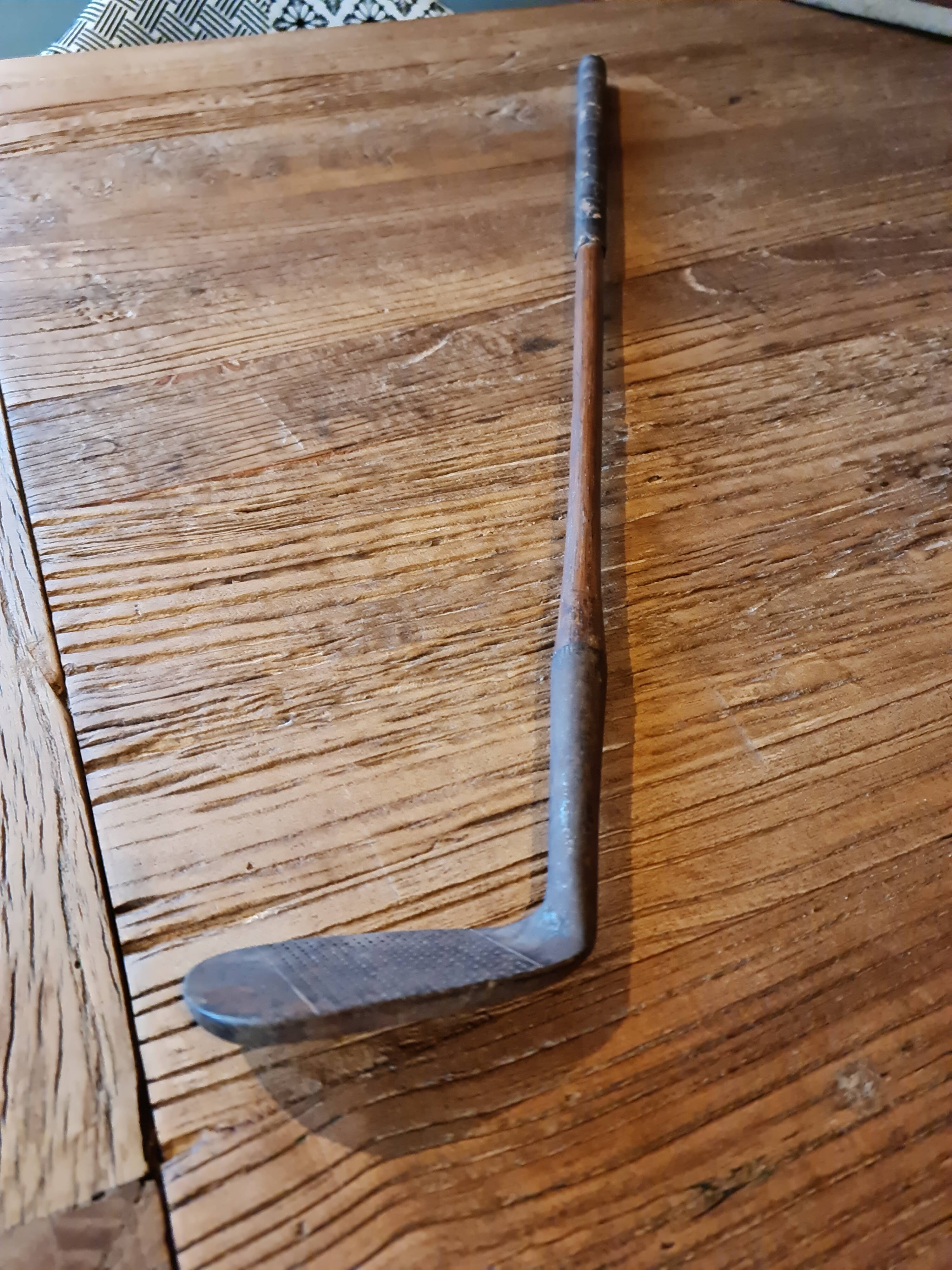 Wood, leather and metal golf club