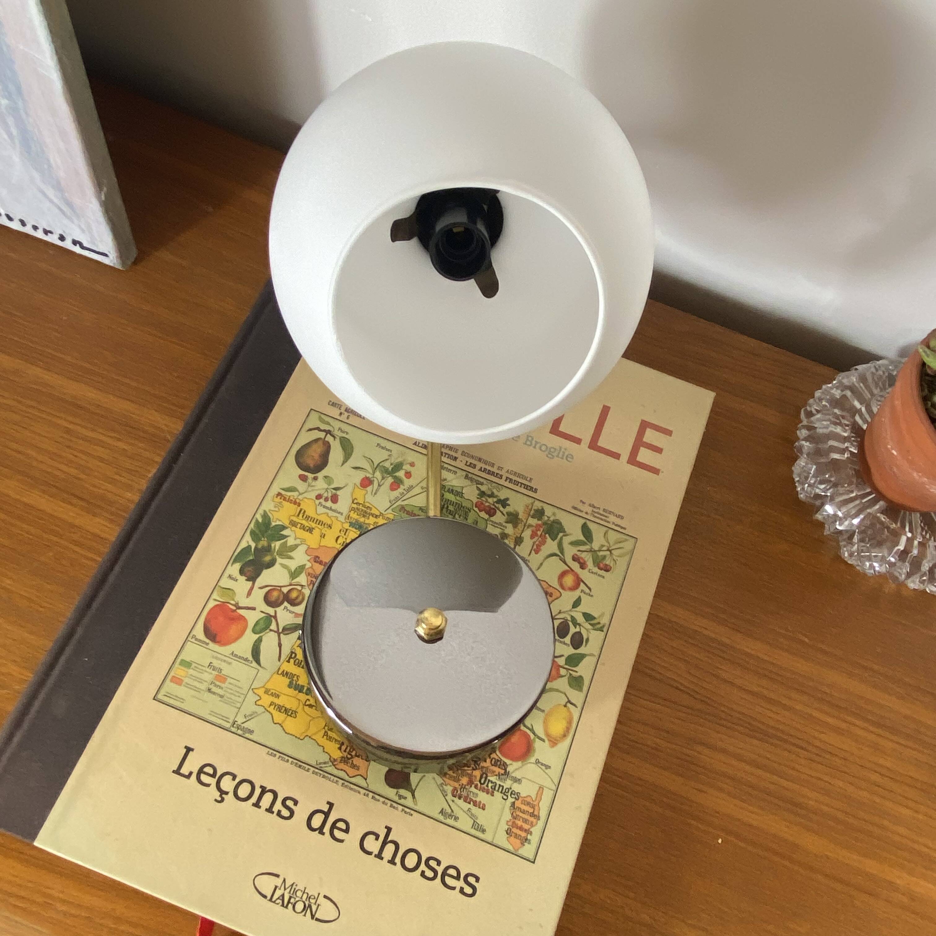 Antique swan neck wall light in brass with a white opaline tulip shade.