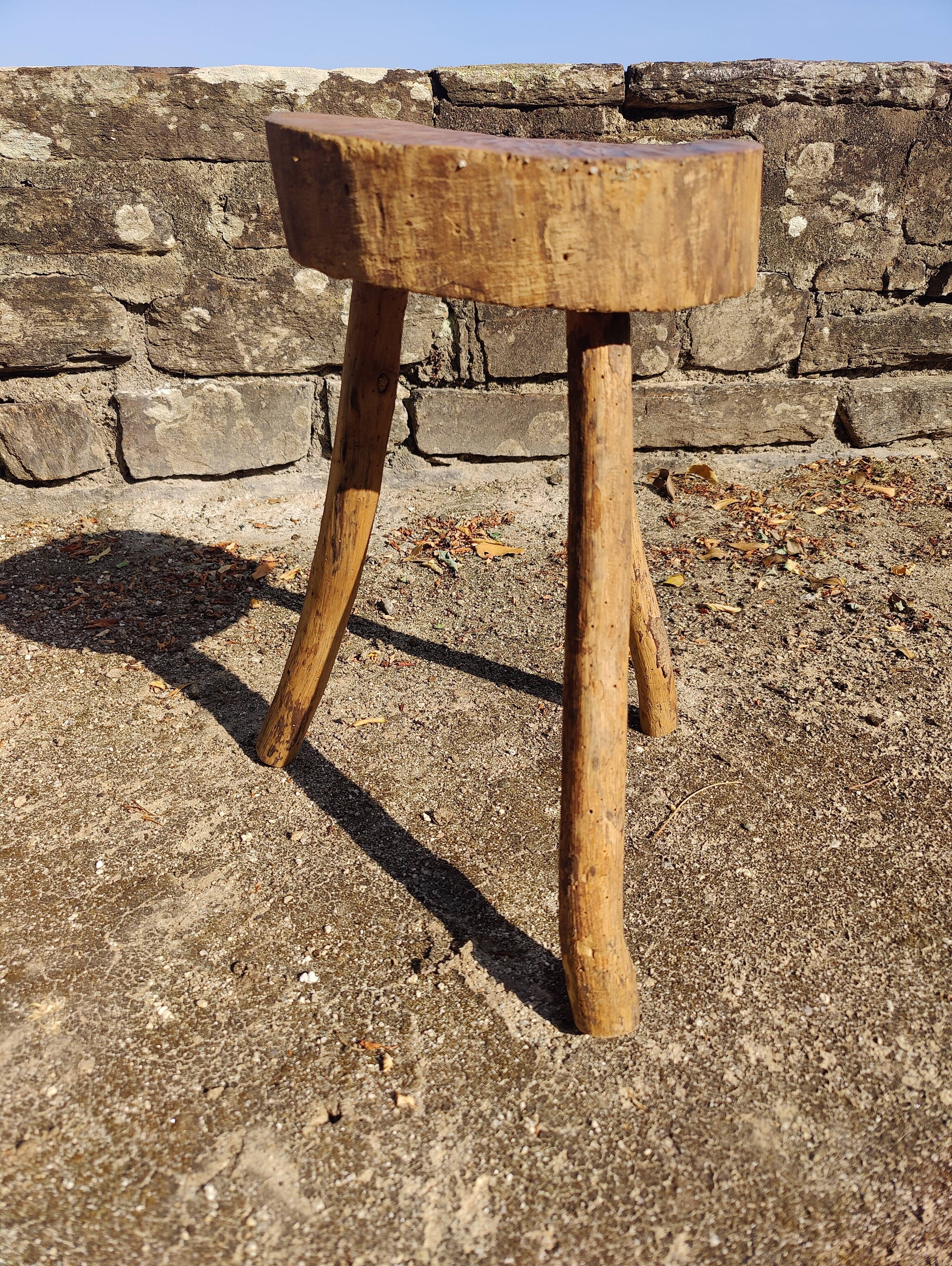 Rustic three-legged stool in minimalist wood in the style of Touret.