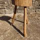 Rustic three-legged stool in minimalist wood in the style of Touret.