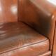 Vintage sheepskin club armchair with a warm colour scheme with black piping