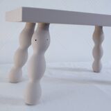 Small vintage wooden bench renovated in pinkish beige