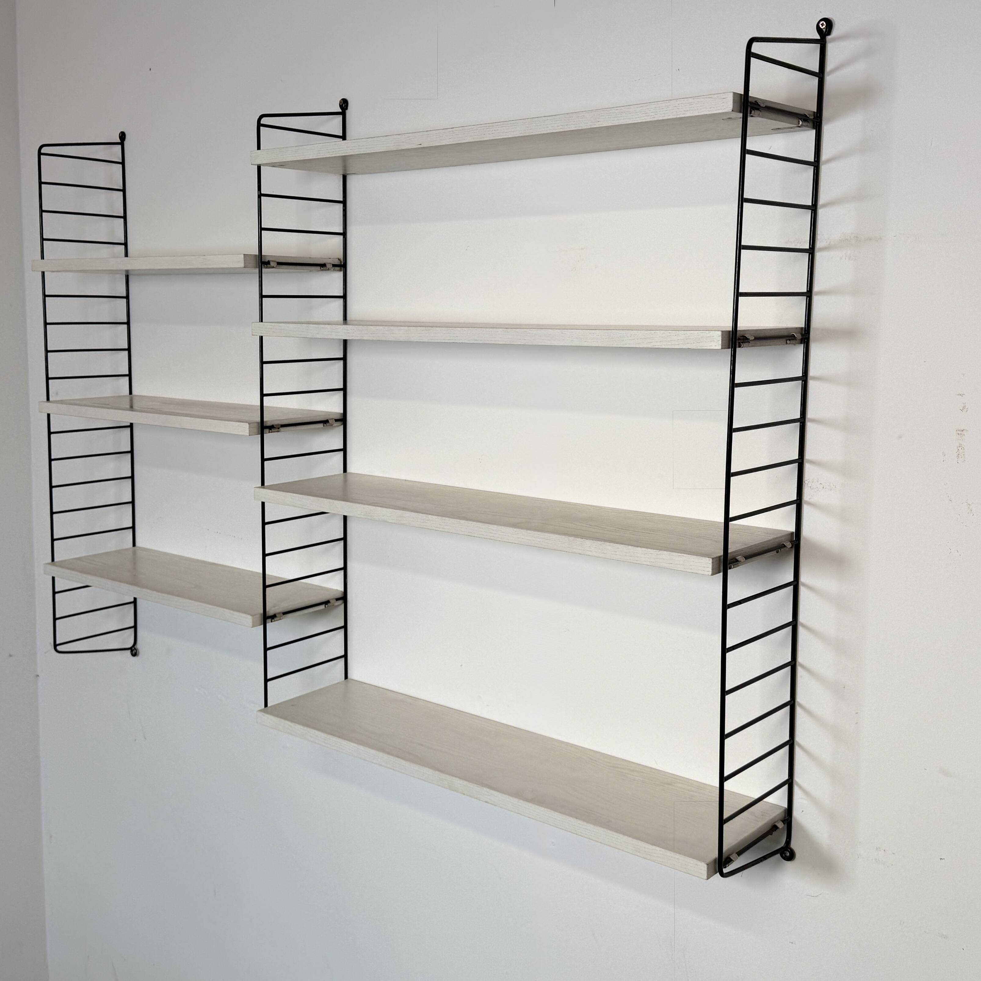 Vintage Nisse Strinning wall rack with 7 white shelves