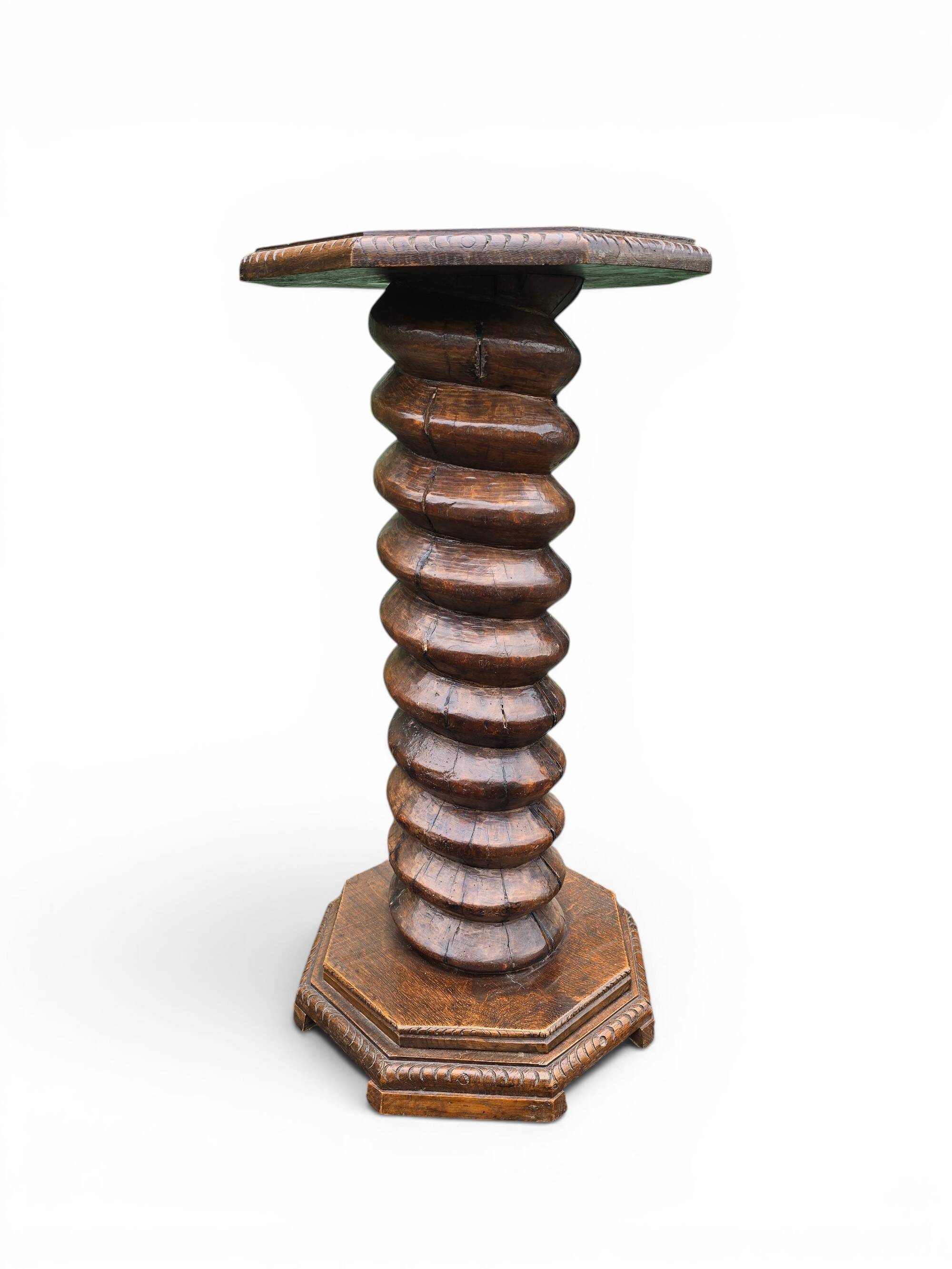 Antique carved solid oak pedestal, octagonal top and turned column.