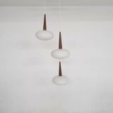 Set of three milk glass and teak pendant lights model NG74 by Louis Kalff for Philips, The Netherlan
