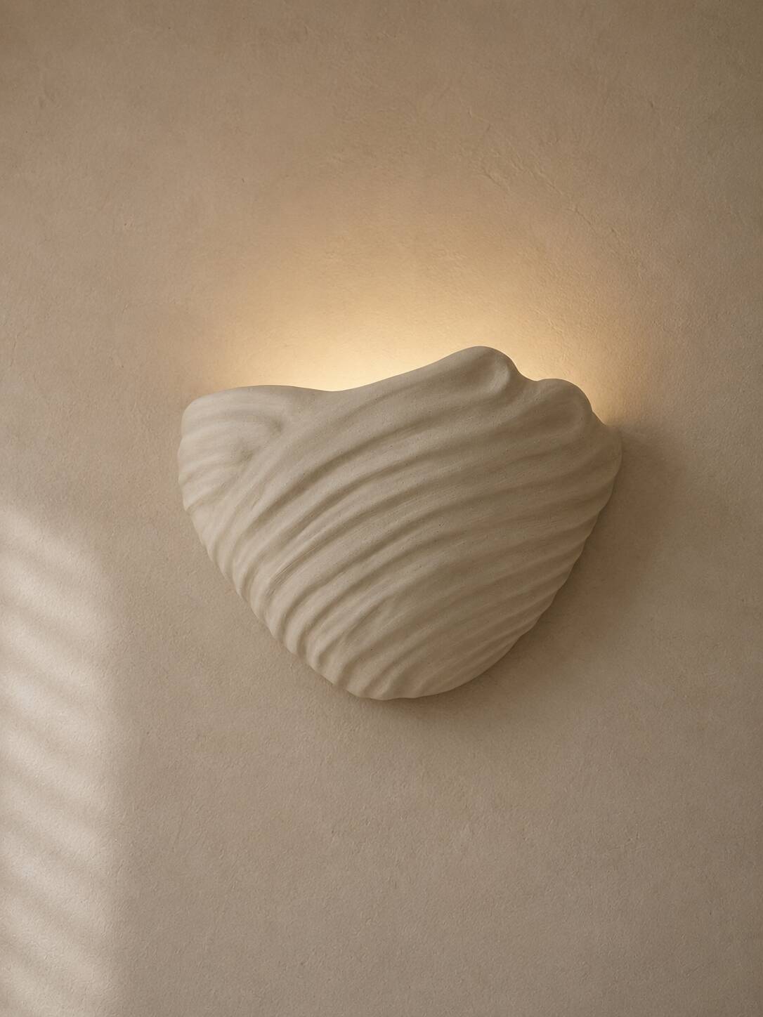 Shell-shaped ceramic applique handcrafted.