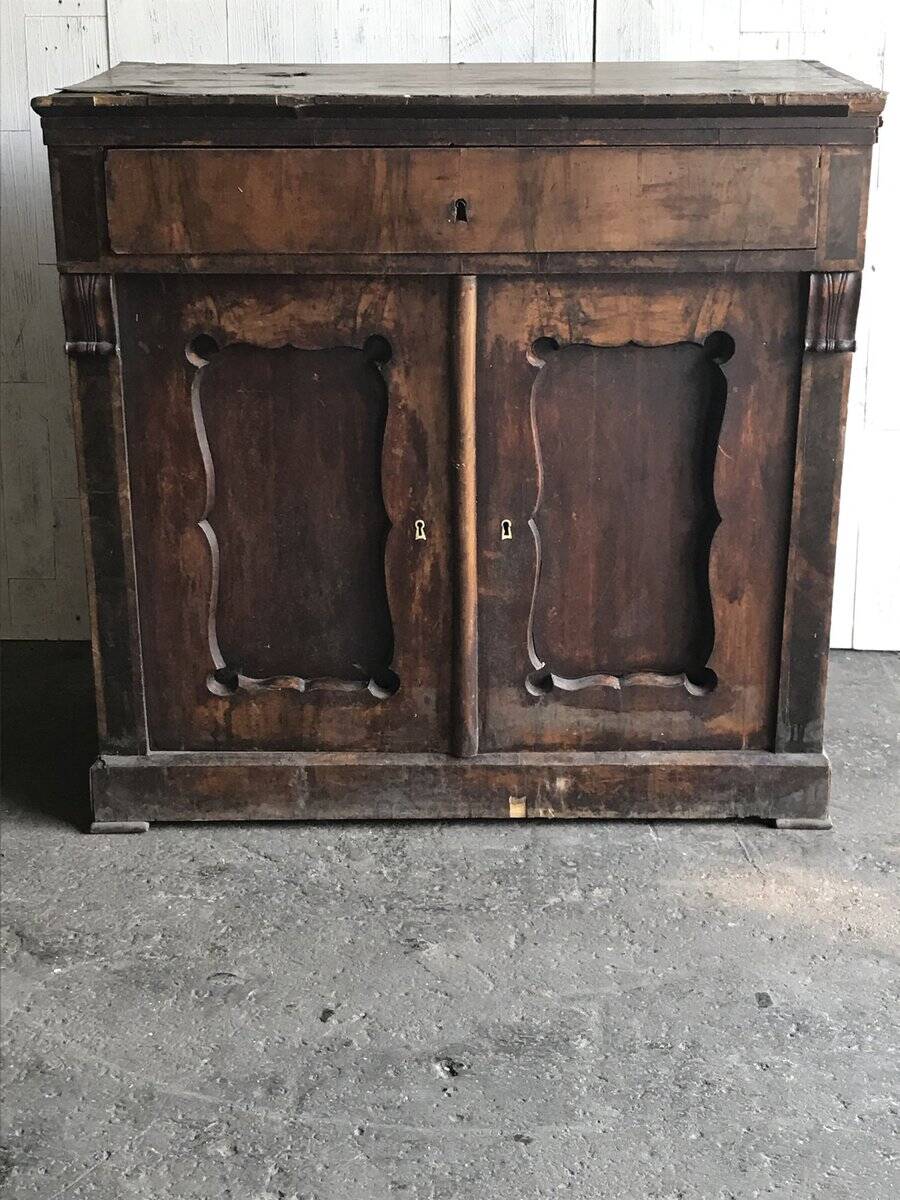 Vintage brown pine dresser with a painted top, moulded panels, and decorative locks.