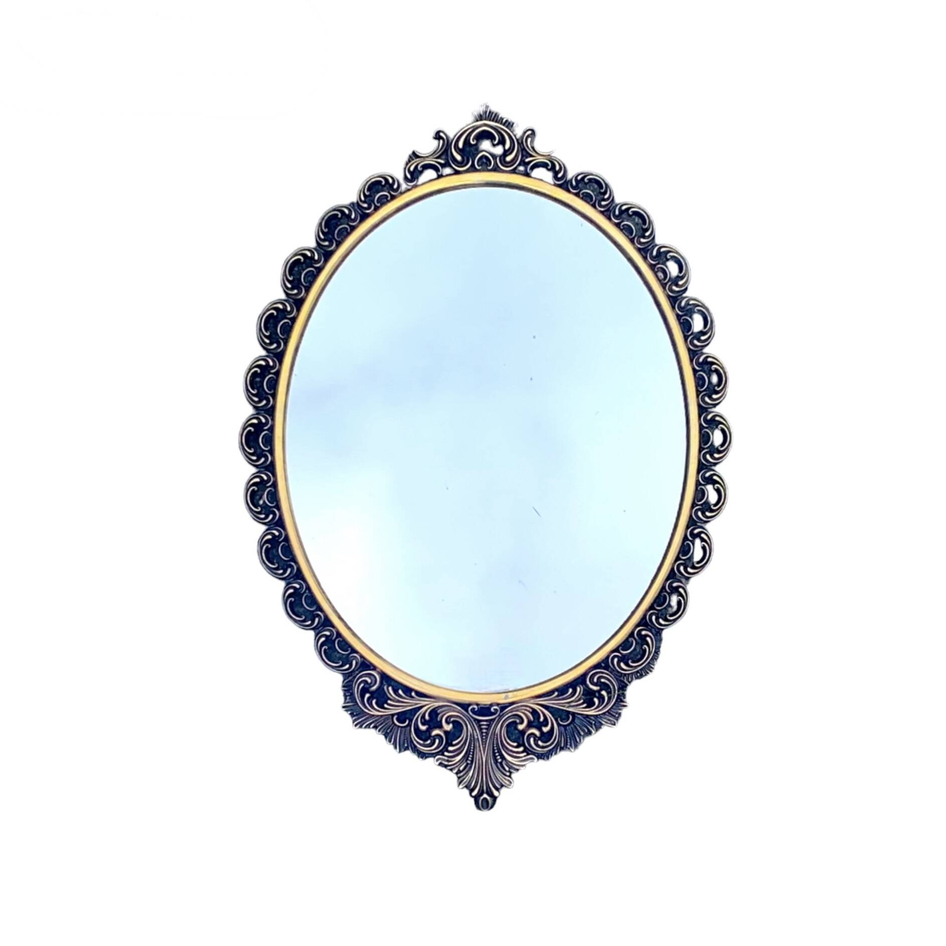 Old oval wall mirror in gilded brass