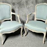 Pair of Louis XV style armchairs in patinated wood, light blue fabric.