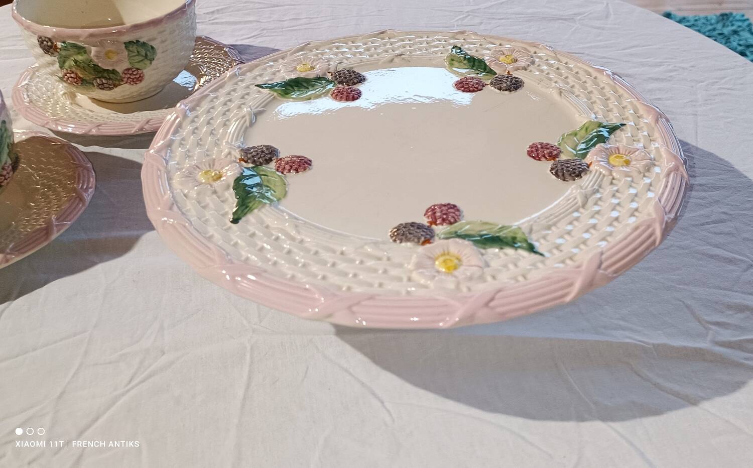 Footed dessert plate in barbotine porcelain, marked FG.