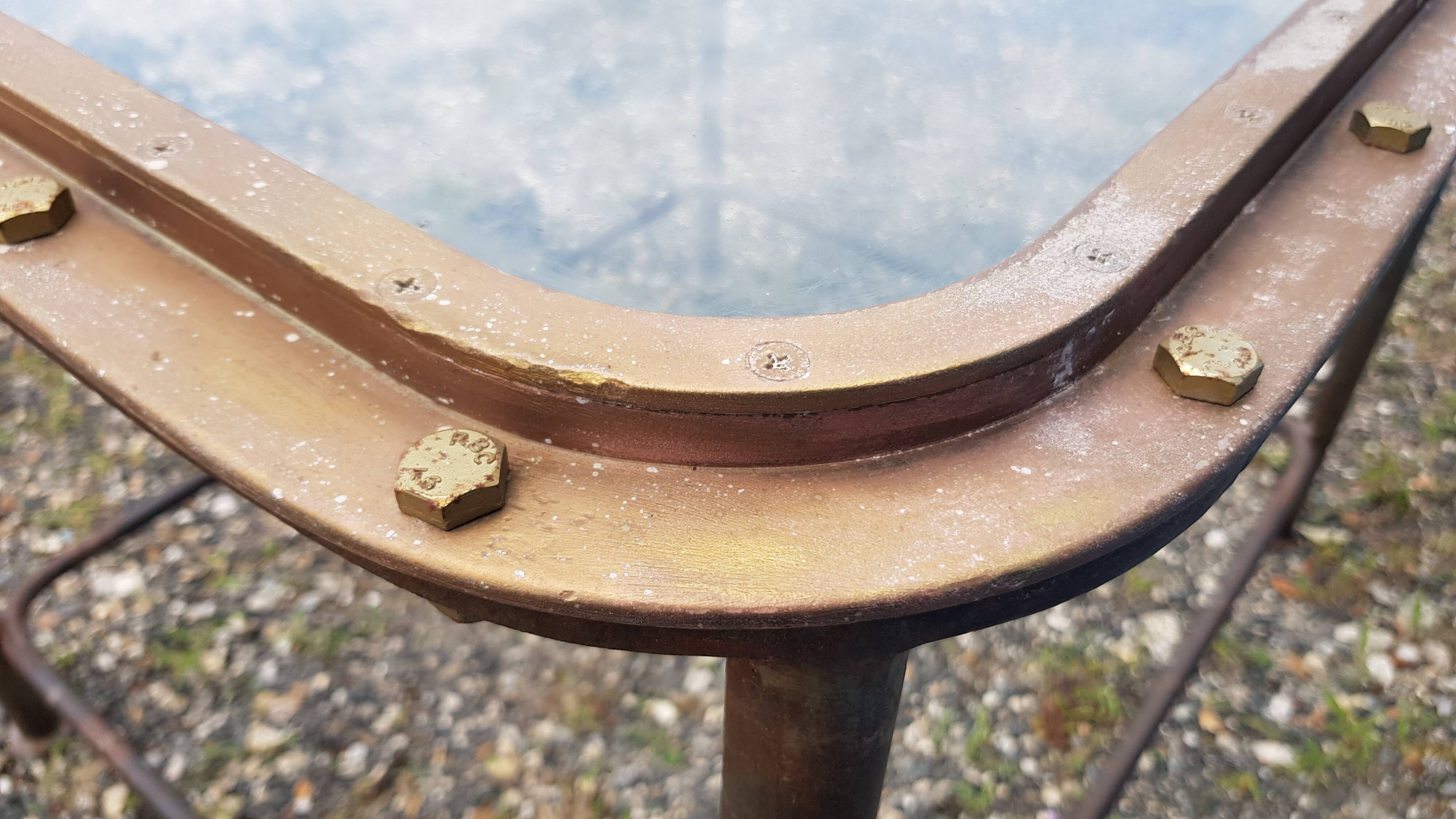 Table with an old ship porthole in brass and a metal base / 100 x 85 x 76 cm