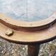 Table with an old ship porthole in brass and a metal base / 100 x 85 x 76 cm