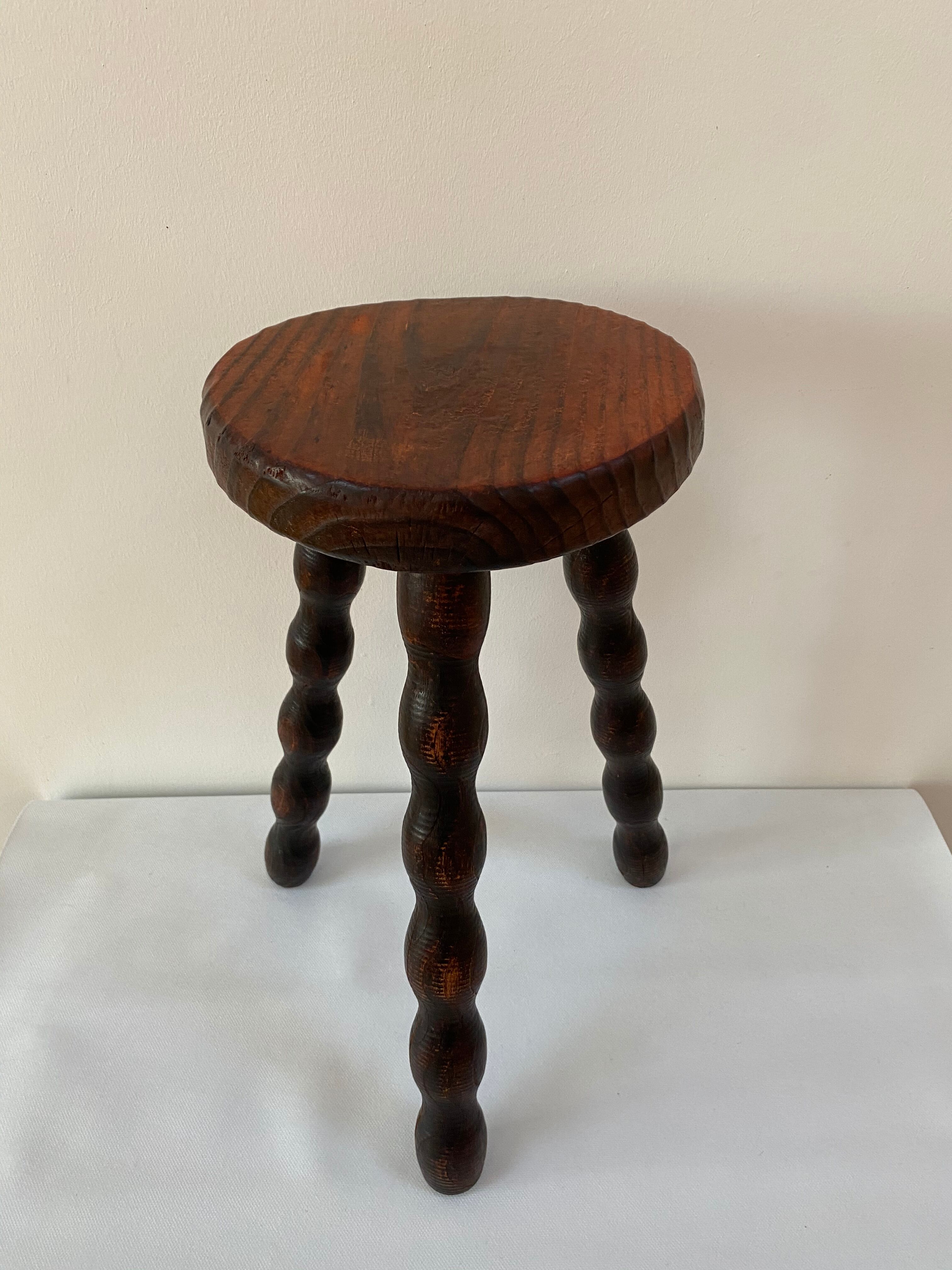 Old tripod stool in solid wood