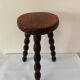 Old tripod stool in solid wood