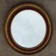 Miroir ovale en bois doré 76 x 67 cm