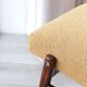 Fauteuil lounge vintage jaune avec accoudoirs en tissu bouclé, bois de noyer, style scandinave