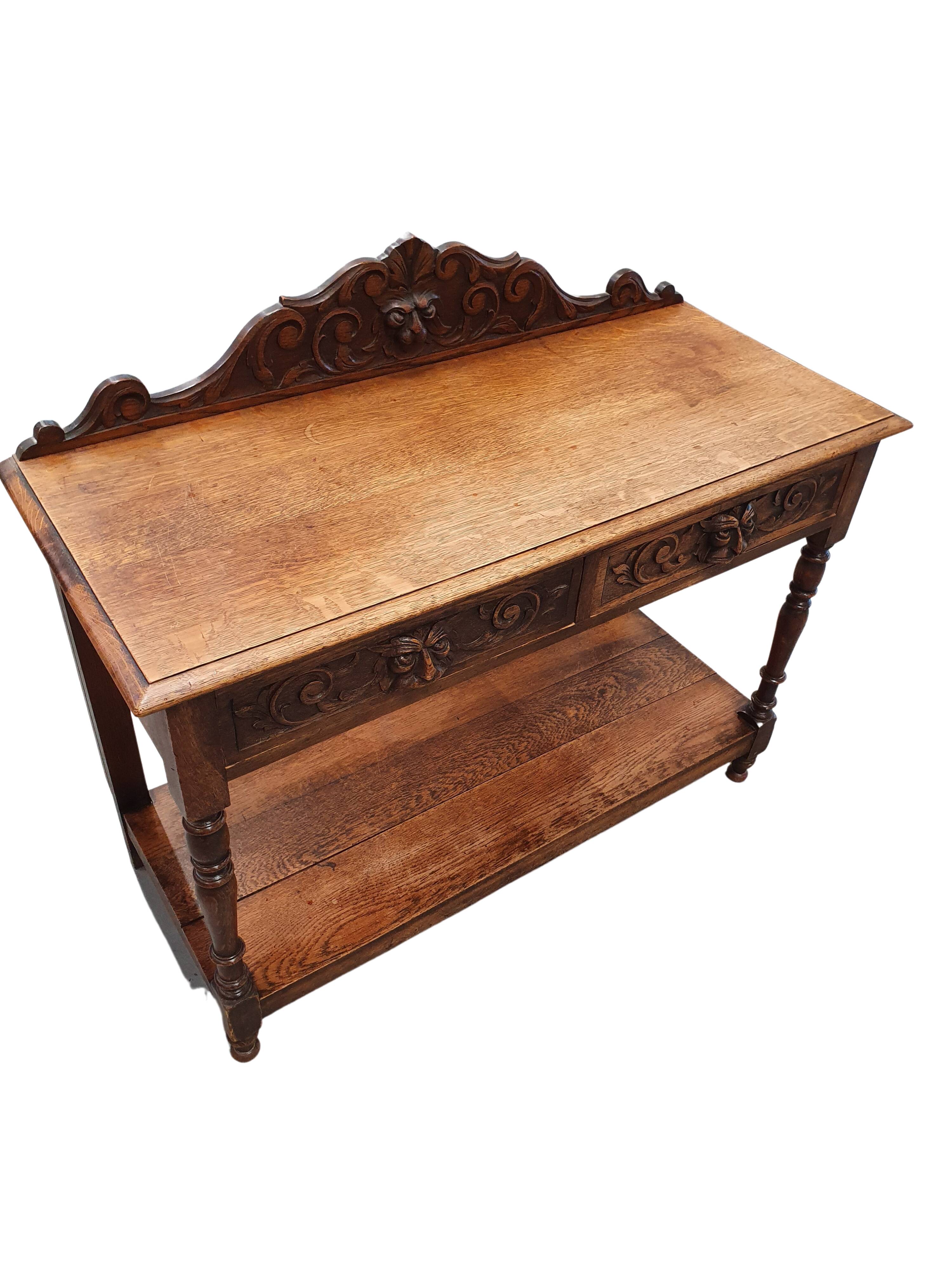 Victorian Gothic Oak side table, decorative carved round 1920. Green Mask decoration