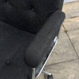 Black mottled fabric and chrome swivel armchair, 1