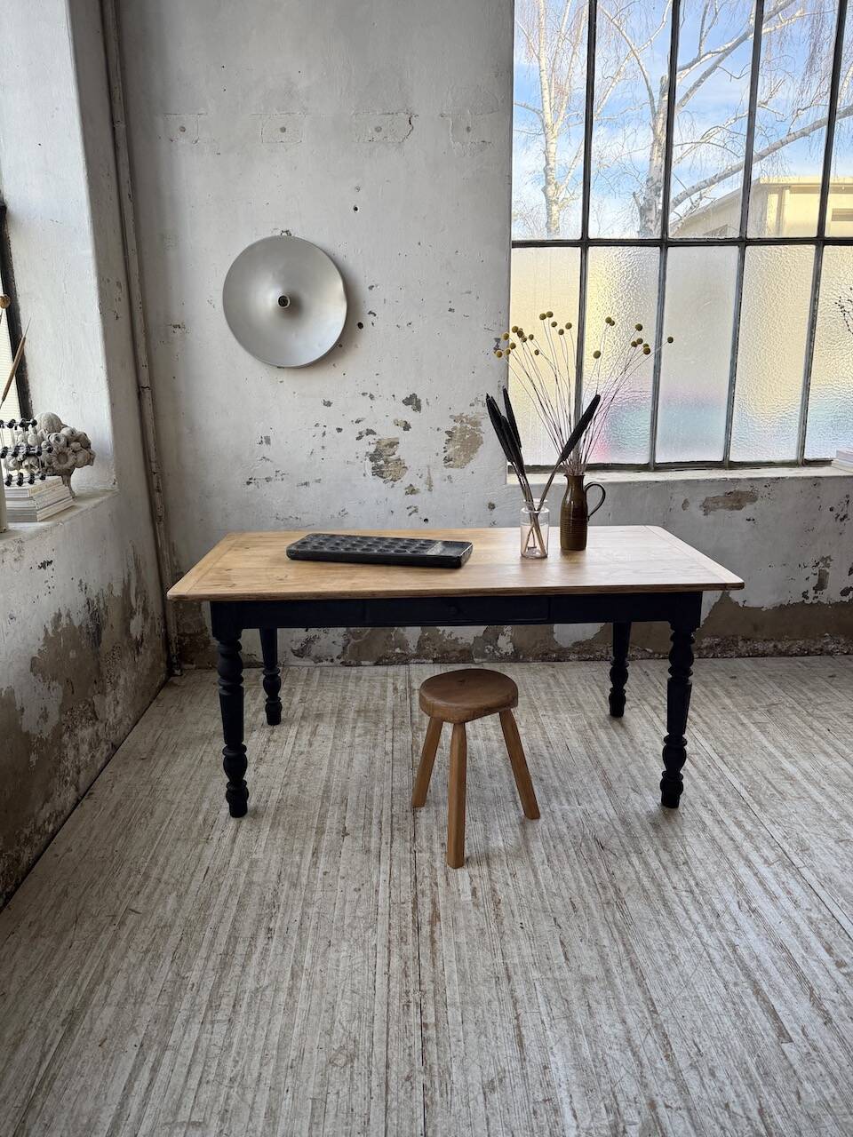 Oak farmhouse table with turned black legs.