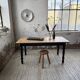 Oak farmhouse table with turned black legs.