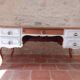 Solid wood desk with distressed white paint.