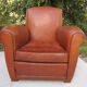 Paire de fauteuils club en cuir