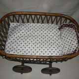 Cradle of doll in rattan on wheels