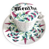 Antique herbal tea cup with mint infusion