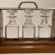 Portable Art Deco liquor cabinet in mahogany & metal with 3 Baccarat crystal bottles.