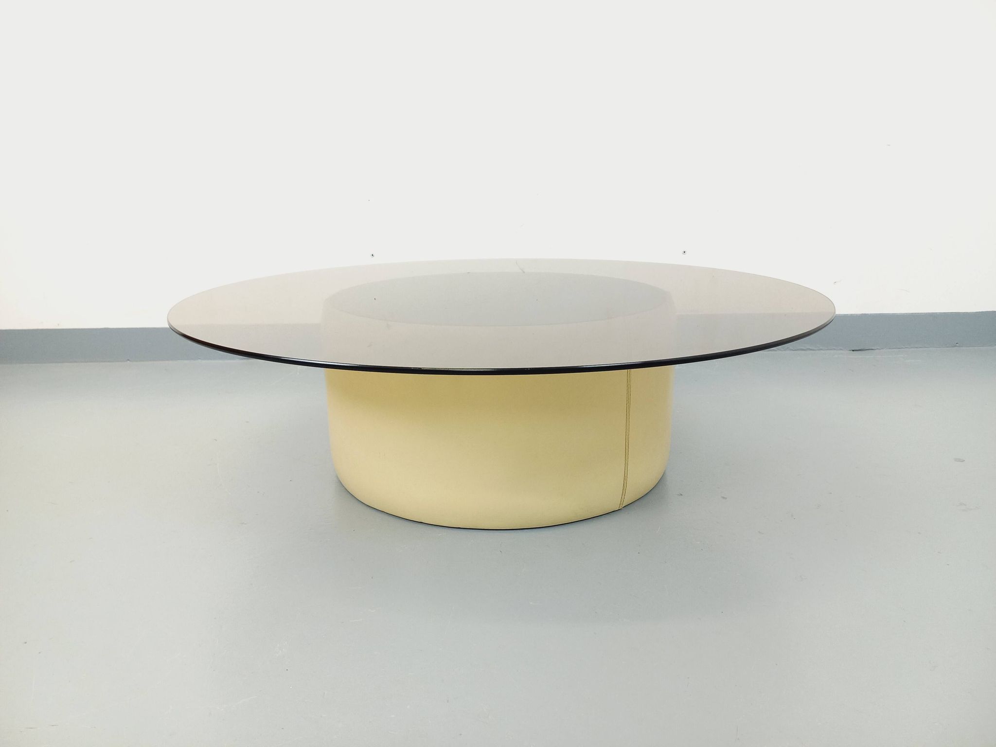 Vintage round coffee table in glass, leather, and metal in Space Age style from the 70s.