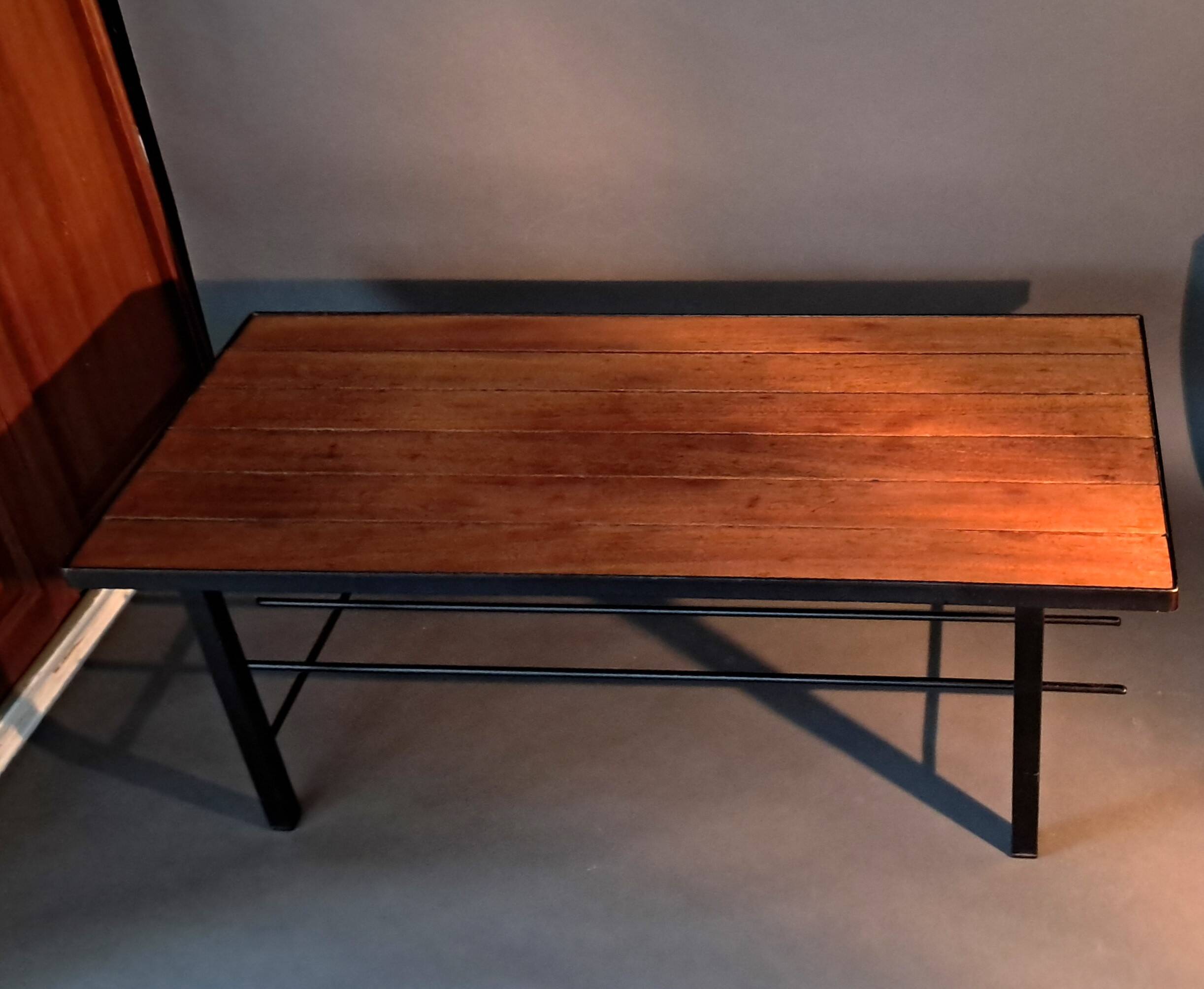Vintage modernist coffee table in teak and black metal.