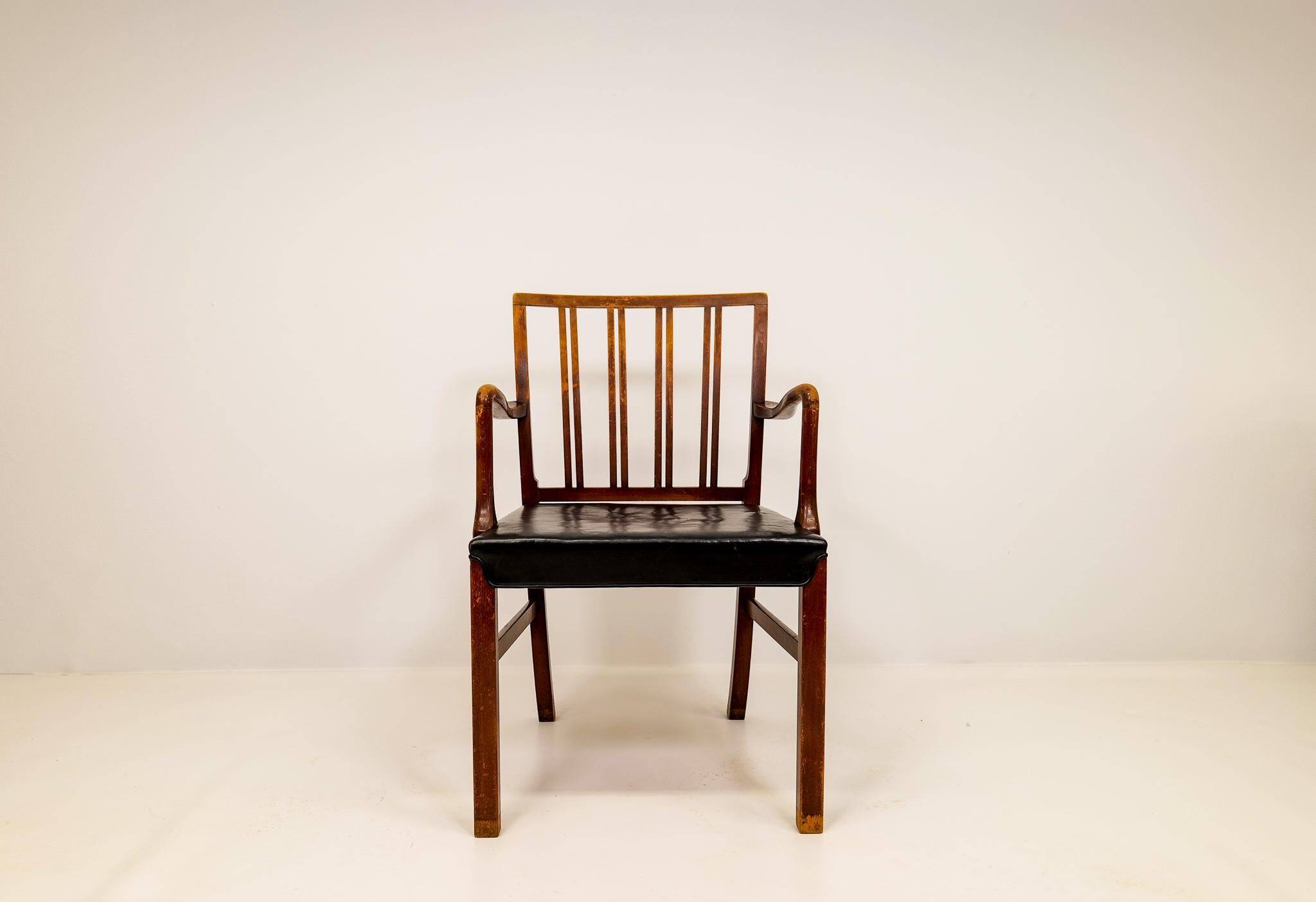 Mid-century armchair by Ole Wanscher for Fritz Hansen, stained beech and leather.