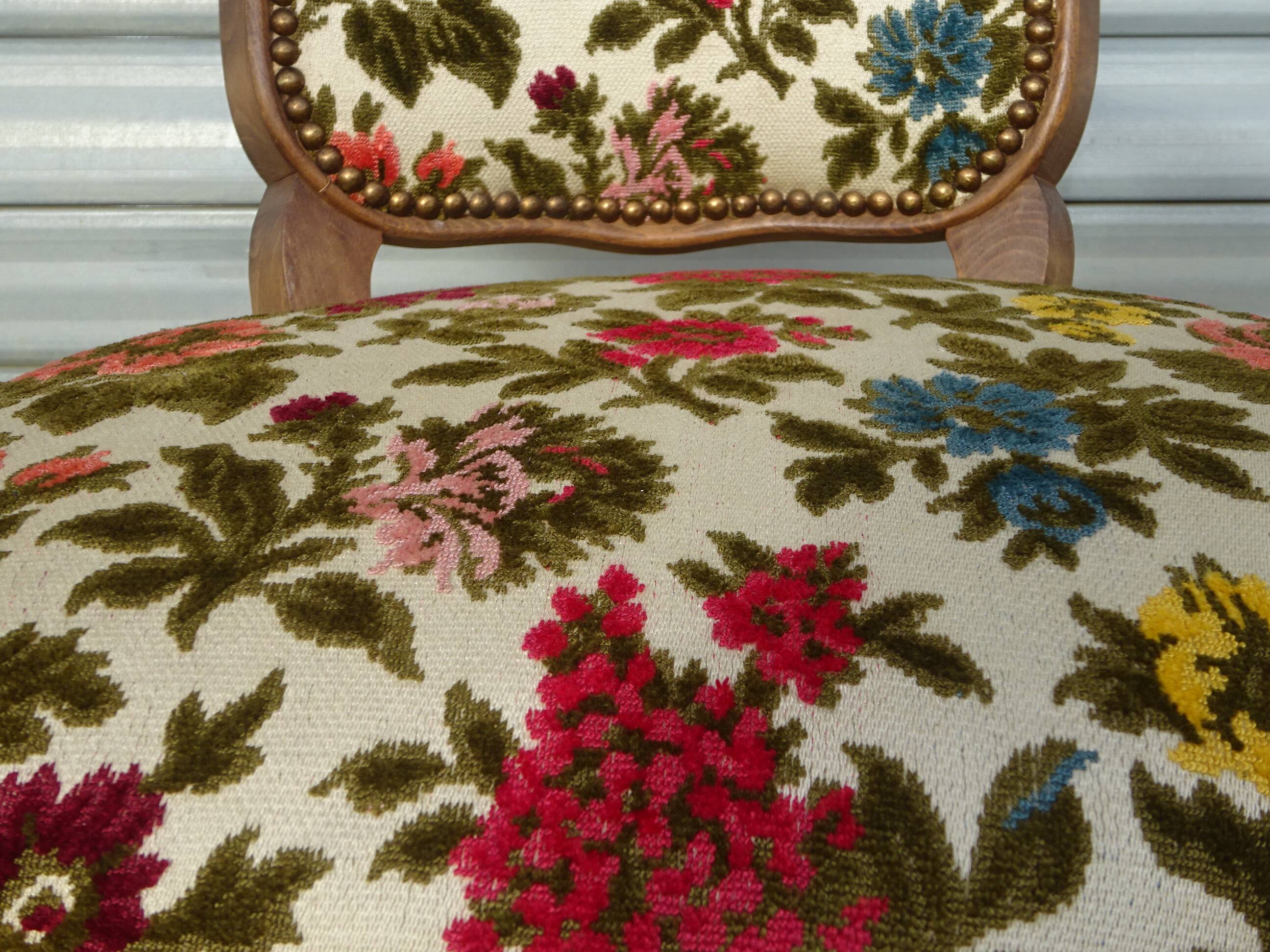 Convertible armchair with brocade fabric and floral patterns.