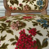 Convertible armchair with brocade fabric and floral patterns.