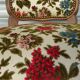 Convertible armchair with brocade fabric and floral patterns.