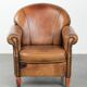 Sheepskin armchair with a beautiful vintage look and decorative nail finish