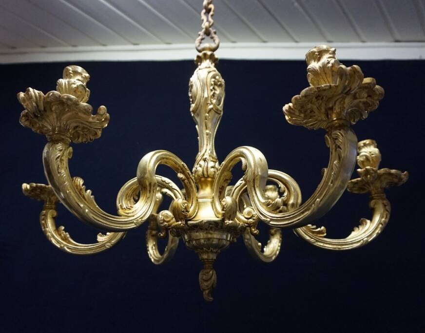 Massive bronze chandelier for candles.